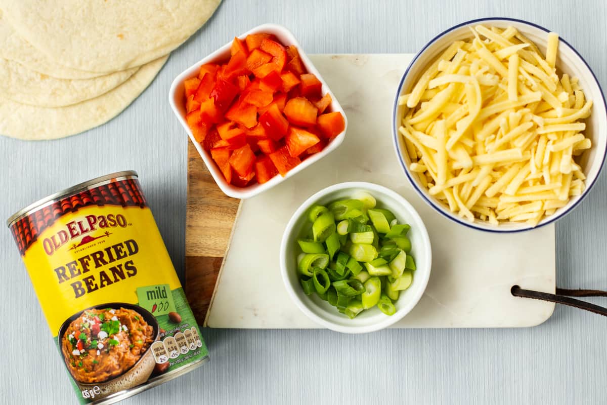 Quesadilla ingredients laid out on a board.