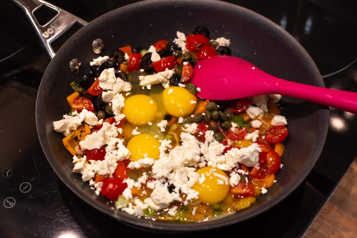 Uncooked Mediterranean scrambled eggs with feta cheese.