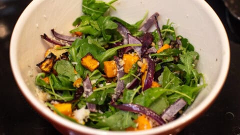 Butternut squash salad in a mixing bowl.