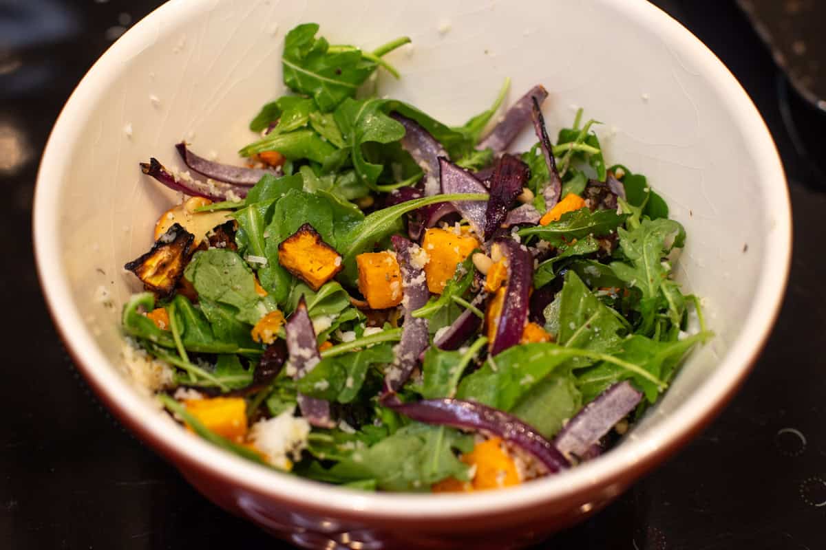 Butternut squash salad in a mixing bowl.