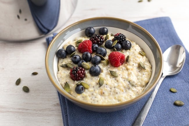 Superfood porridge with quinoa, flax and chia, as well as the usual oats. Topped with pumpkin seeds and berries for even more goodness! A super healthy vegetarian / vegan / gluten-free breakfast.